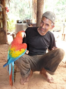 A local Brazalian farmer with a Scarlet Macaw. Credit: JM Ochoa-Quintero